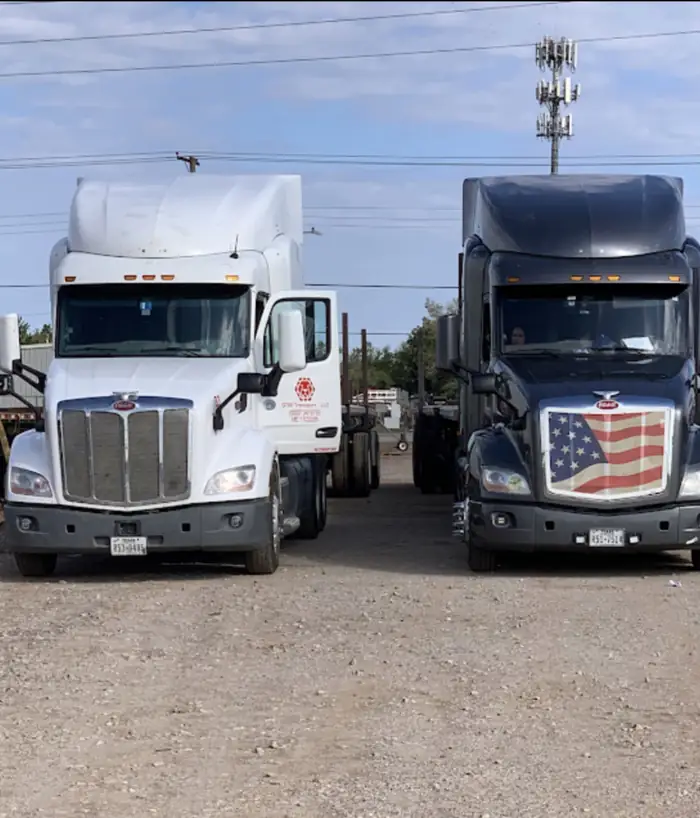 GTM Transport red Freightliner flatbed hauling steel pipe and drilling components
