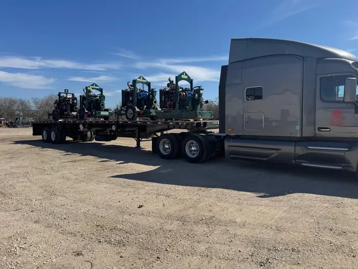 GTM Transport flatbed loaded with articulating boom lifts